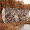 Pop-up hunting blind with camouflage pattern, adjustable windows, and dog doors for 1-3 people by the water.