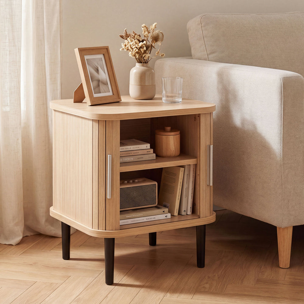 Natural fluted nightstand with raised support legs and a wide tabletop, ideal for bedside essentials and decor.