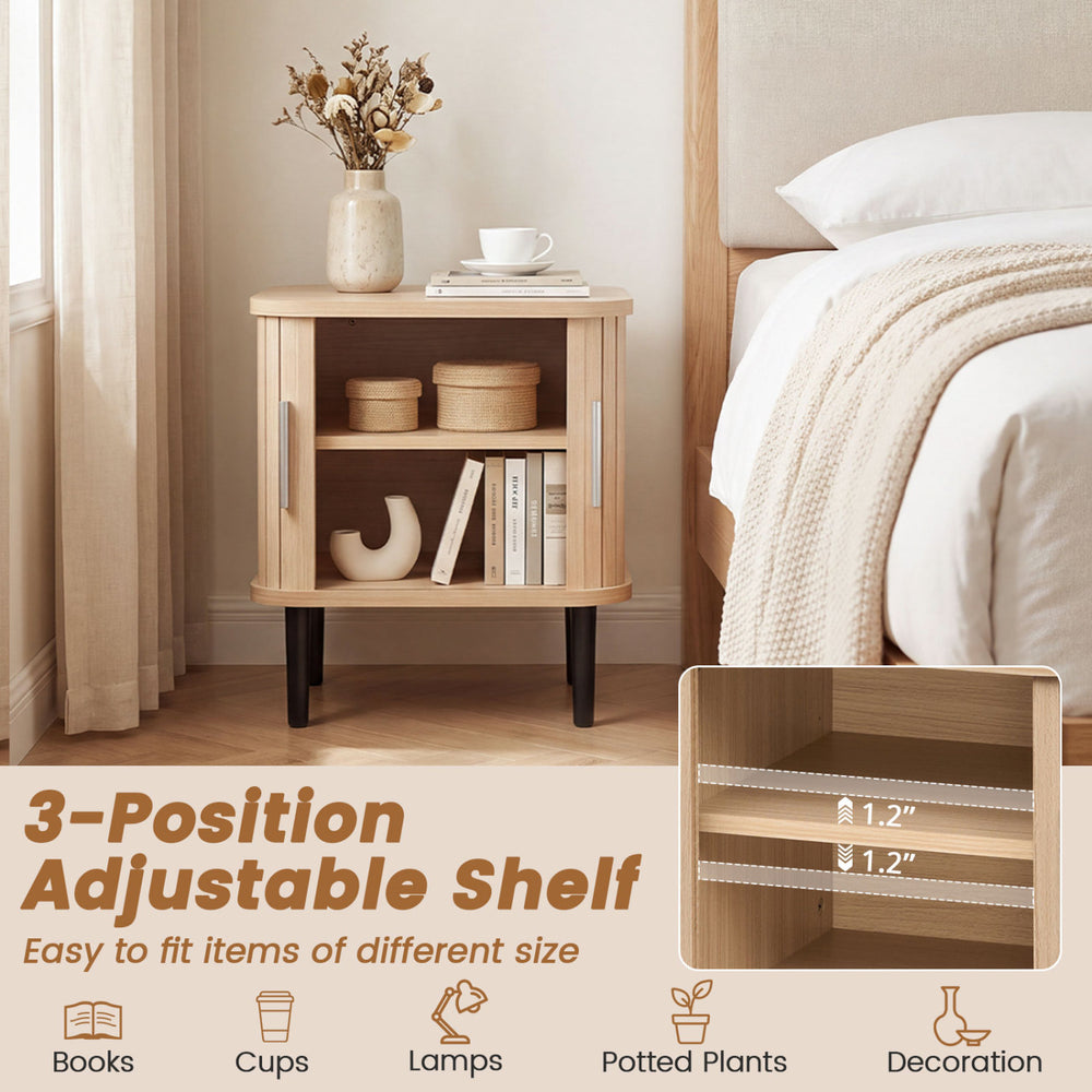 Fluted nightstand with sliding doors, adjustable shelf, and ample storage for cups, lamps, and decorations in natural finish.