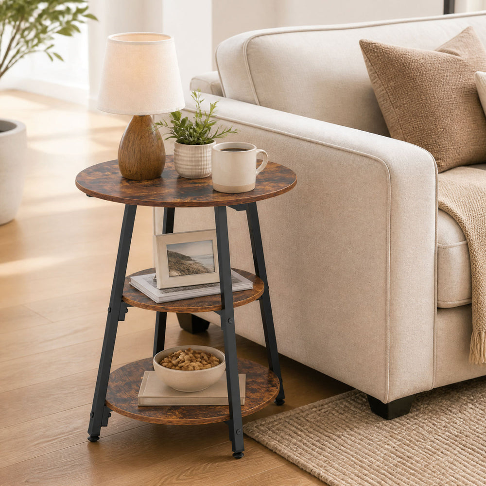 Rustic brown industrial side table with three tiers, perfect for storing snacks and magazines in your living room.