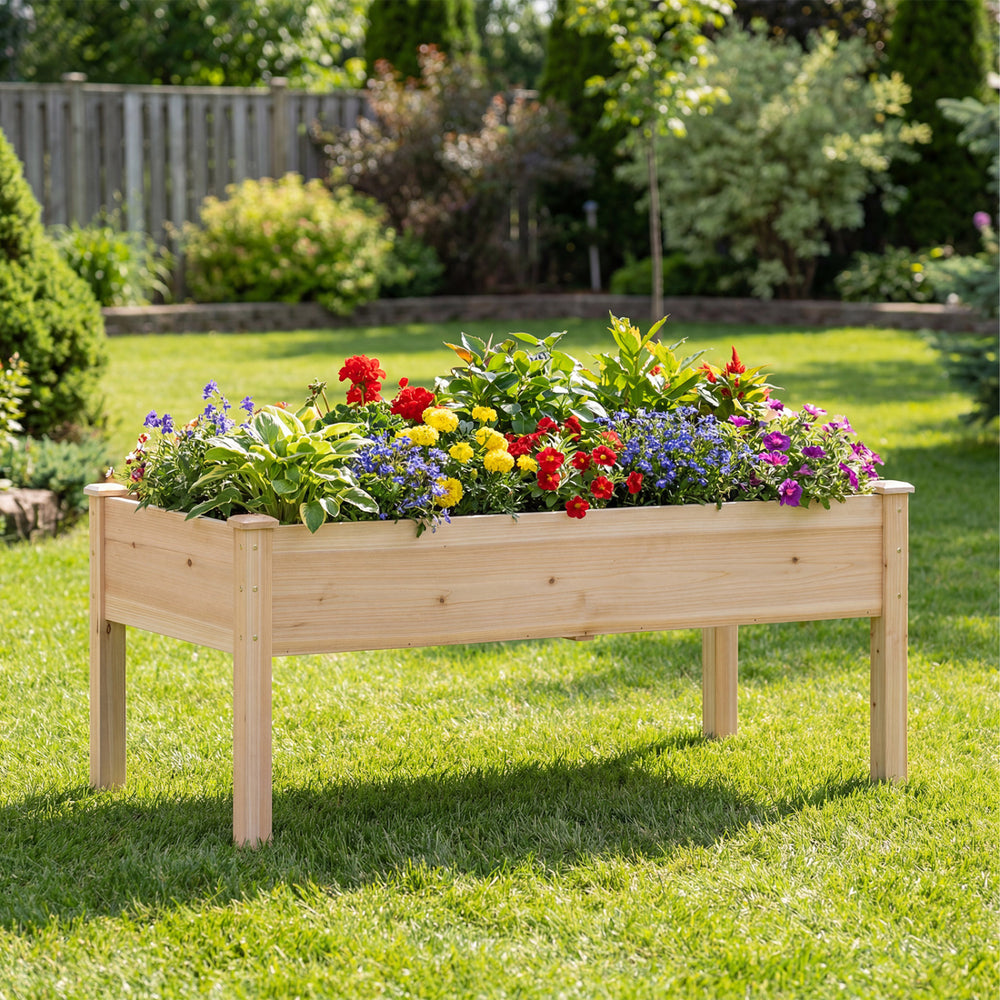 Wooden raised garden bed made of natural fir wood, featuring vibrant flowers, ideal for outdoor gardening.