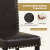 Close-up of a thick padded seat of a faux leather dining chair with nailhead accents, ideal for kitchen or dining use.
