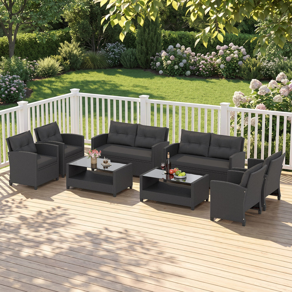 Patio rattan conversation set featuring a coffee table, loveseat, and two sofas, perfect for outdoor relaxation.