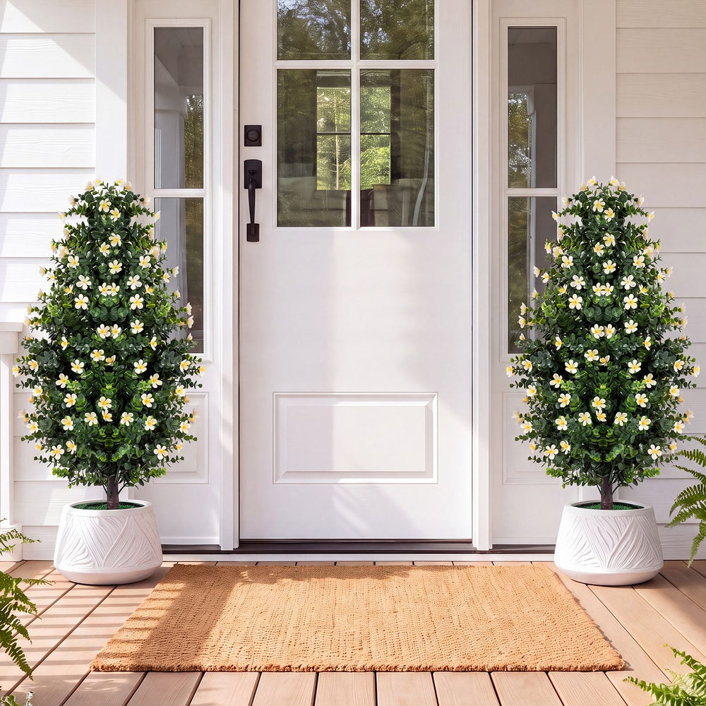 Set of 2 artificial topiary trees with white blossoms in weighted pots, perfect for enhancing front porches or home corners.