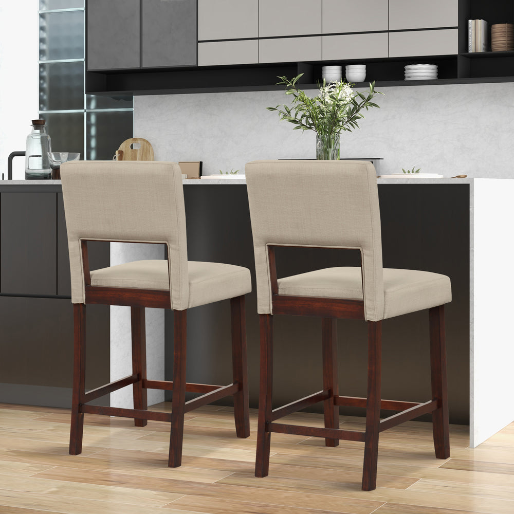 Two beige bar chairs with hollowed backs and rubber wood legs, perfect for modern kitchens or cafes.