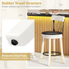 Close-up of rubber wood bar stool leg with protective foot pad, featuring a swivel seat and tufted rivets for modern.