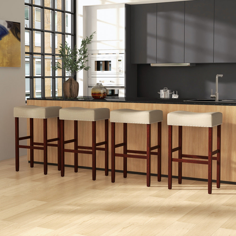 Backless beige upholstered bar stools with solid rubber wood legs, ideal for kitchen or dining areas, featuring.