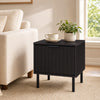 Black modern nightstand featuring a vertical-striped storage drawer, perfect for compact bedside layouts and refined decor.