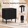 Black modern nightstand with vertical-striped storage drawer and adjustable foot pads for enhanced stability in small spaces.