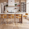 Set of 2 orange corduroy counter height stools with armless design, padded seat, and footrest for kitchen use.