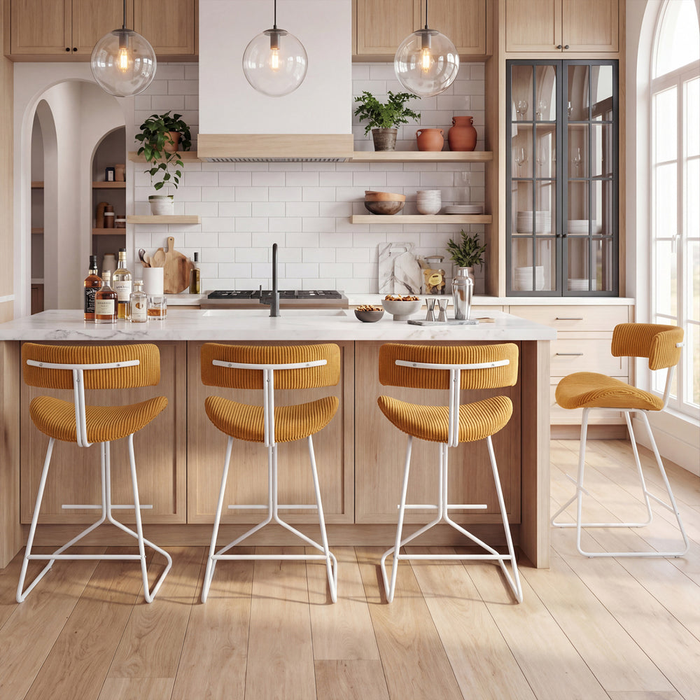 Set of 2 orange corduroy counter height stools with armless design, padded seat, and footrest for kitchen use.