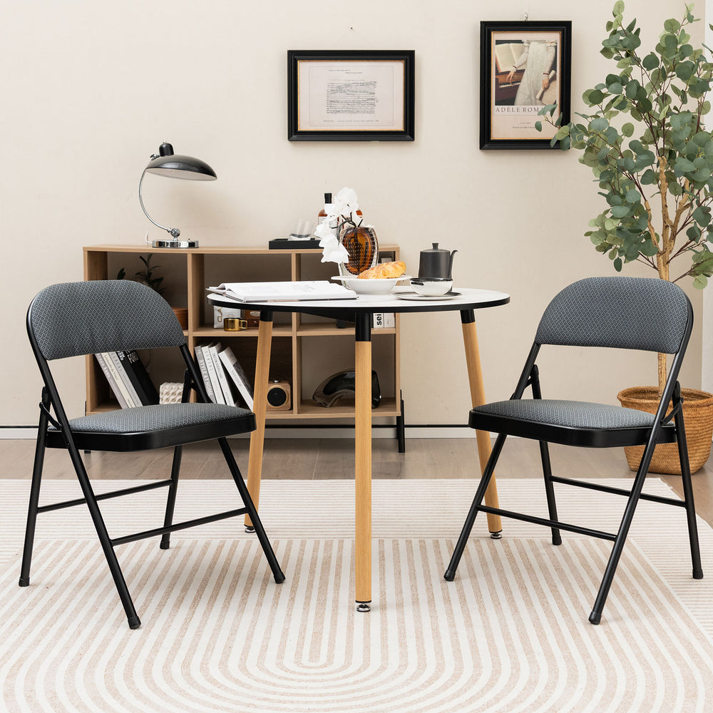 Folding chair set with upholstered seats and fabric backrests, perfect for dining rooms or meetings, featuring a.
