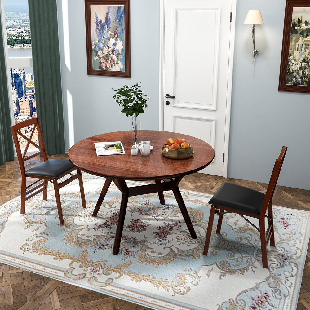Round dining table with two folding chairs in brown, featuring soft cushions and sturdy rubber wood for elegant dining.
