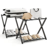 Folding metal luggage rack in black with suitcase, shoes, and bags, ideal for modern bedrooms or hotel use.