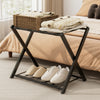 Folding metal luggage rack in black with shoes stored below, ideal for bedroom or hotel use, featuring sturdy iron.