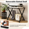 Folding metal luggage rack in black with removable slatted shelf, ideal for storing suitcases and shoes in modern.