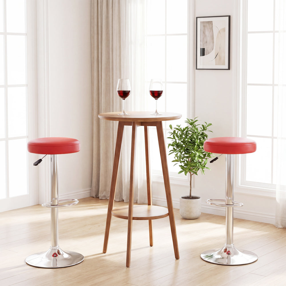 Height-adjustable swivel bar stools in red with a round wooden table, perfect for modern dining spaces.