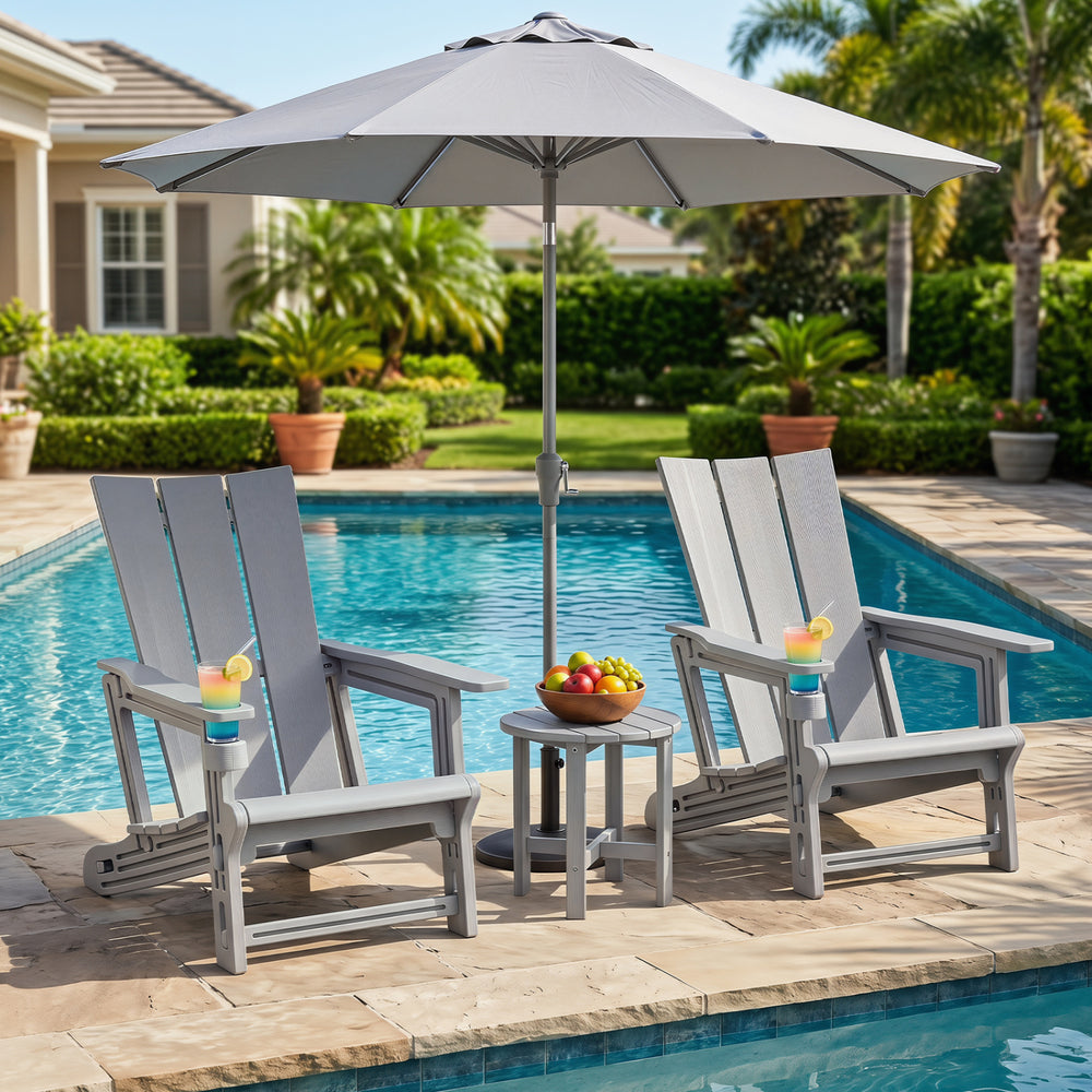 Two gray Adirondack chairs with cup holders beside a pool, made of all-weather HDPE plastic for outdoor relaxation.