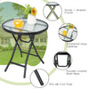 Round patio side table with tempered glass top, sturdy X-shaped frame, and non-slip foot pads for indoor or outdoor use.