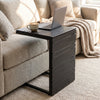 C-shaped side table in black with a slatted wood-plastic top, ideal for convenient placement beside sofas or beds.