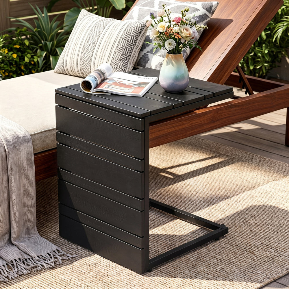 C-shaped black side table with slatted wood-plastic top, perfect for indoor and outdoor use beside sofas or chairs.