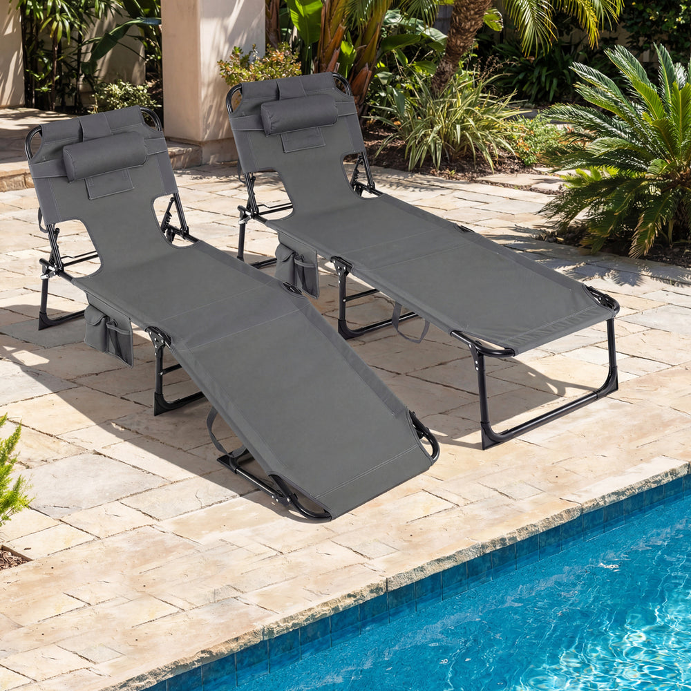 Set of 2 gray portable chaise lounge chairs with adjustable backrests, ideal for poolside relaxation and easy storage.