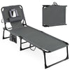 Portable gray tanning chair with adjustable backrest, removable pillow, and storage pockets for outdoor relaxation.