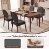 Set of two black upholstered linen fabric kitchen side chairs with padded seats and ergonomic backrests for comfort.