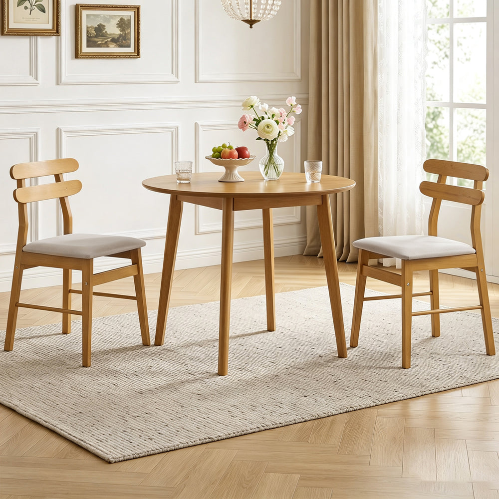 Two modern upholstered dining chairs in natural wood with beige fabric, designed for comfort and style in dining spaces.