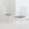 Set of 2 white wooden dining chairs with rubber wood legs and padded seats, perfect for living room or dining area.