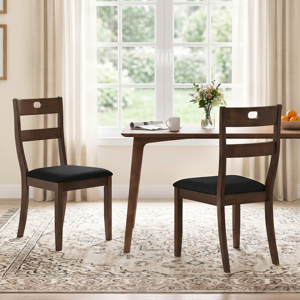 Set of 2 walnut wooden dining chairs with padded seats and ergonomic backrests, ideal for dining rooms and kitchens.