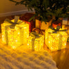 Set of 3 illuminated Christmas gift boxes with shimmering sequins, festive bows, and warm LED lights for holiday charm.