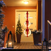 Three lighted Christmas wreaths with warm white LEDs and bows, hung on a red ribbon, perfect for festive outdoor decor.
