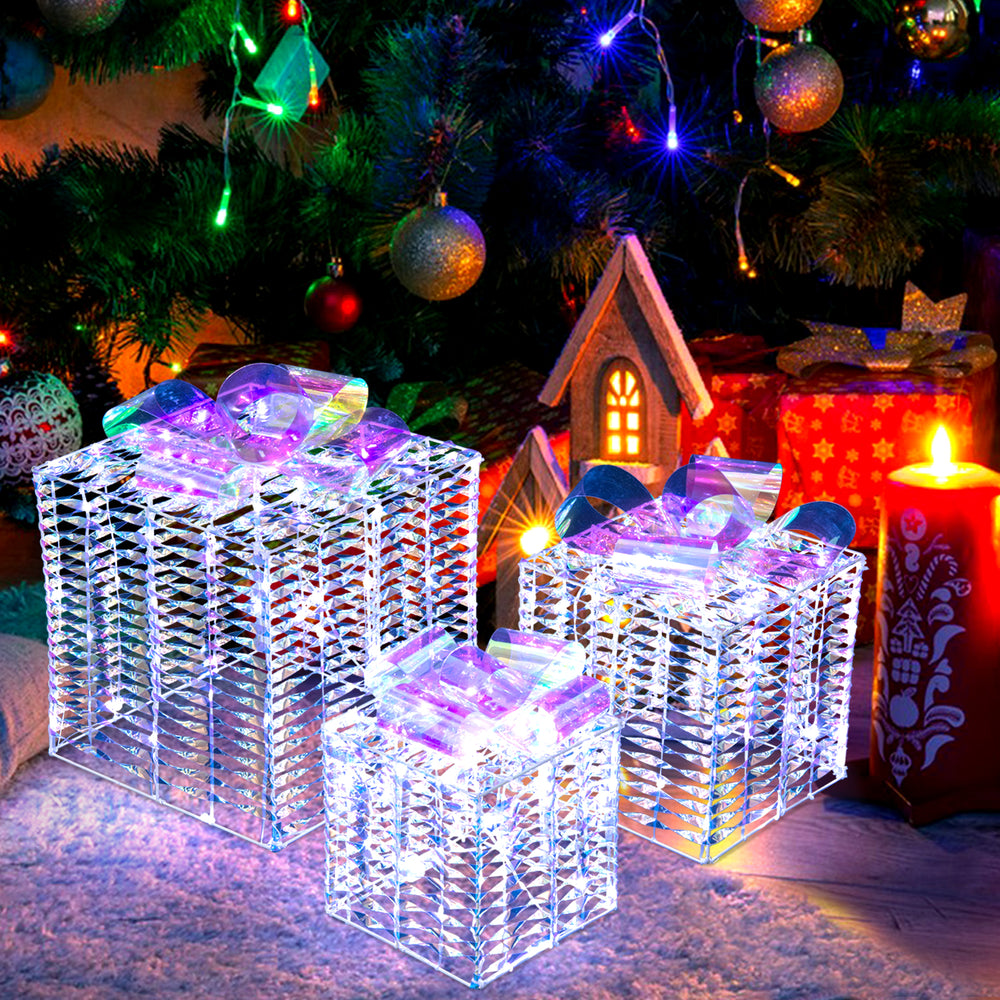 Set of 3 iridescent Christmas gift boxes with bows, illuminated by 156 cold white lights for festive outdoor decoration.