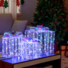 Set of 3 iridescent Christmas gift boxes with bows, illuminated by 156 cold white lights, perfect for festive decor.