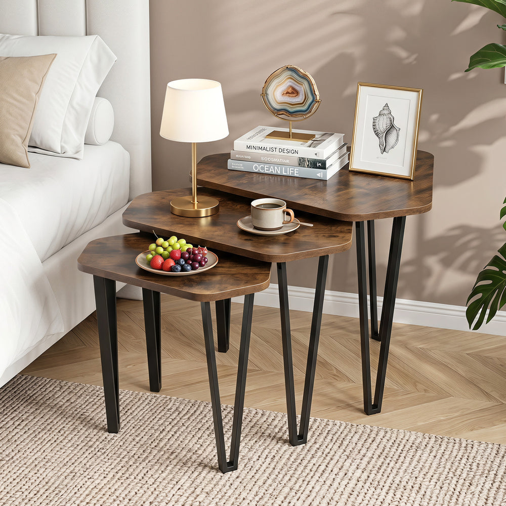 Set of 3 nesting coffee tables with rustic brown engineered wood tops and sturdy metal frames for versatile living room use.