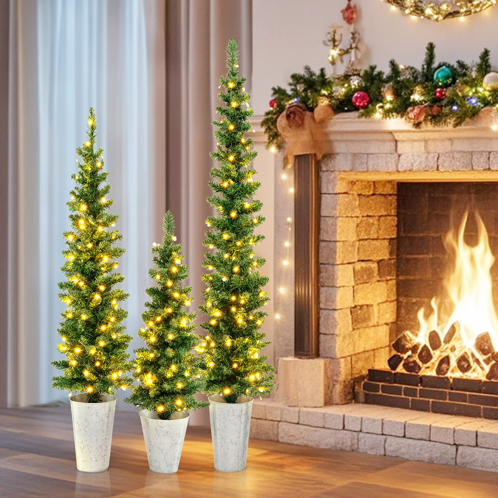 Set of 3 pre-lit artificial Christmas trees with warm white LED lights, perfect for festive home decoration.