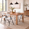 Set of four white foldable plastic chairs with ergonomic backrests, ideal for dining or events, featuring a sturdy design.
