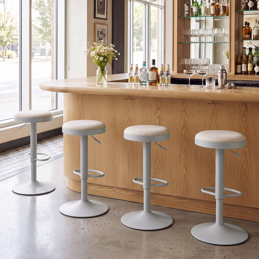 Set of 4 gray kitchen bar stools with height adjustment, padded seats, and D-shaped footrests for versatile use.