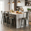 Set of 4 gun metal metal bar stools with backrests, footrests, and stackable design for kitchen island or home bar.