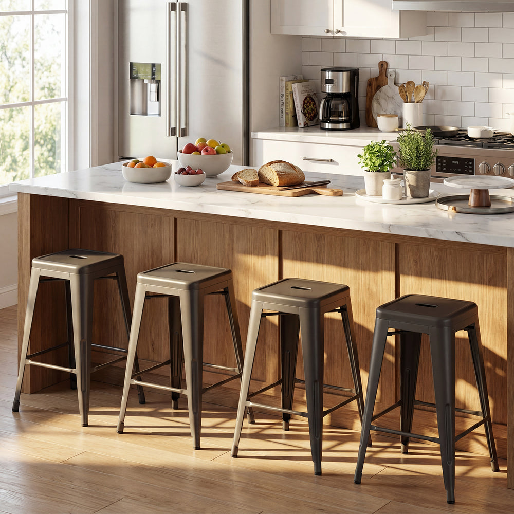 Set of 4 gun metal metal bar stools with backrests, stacked for space-saving convenience in a modern kitchen.