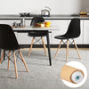 Close-up of a black armless dining chair with beech wood legs, showcasing ergonomic design and modern style for.