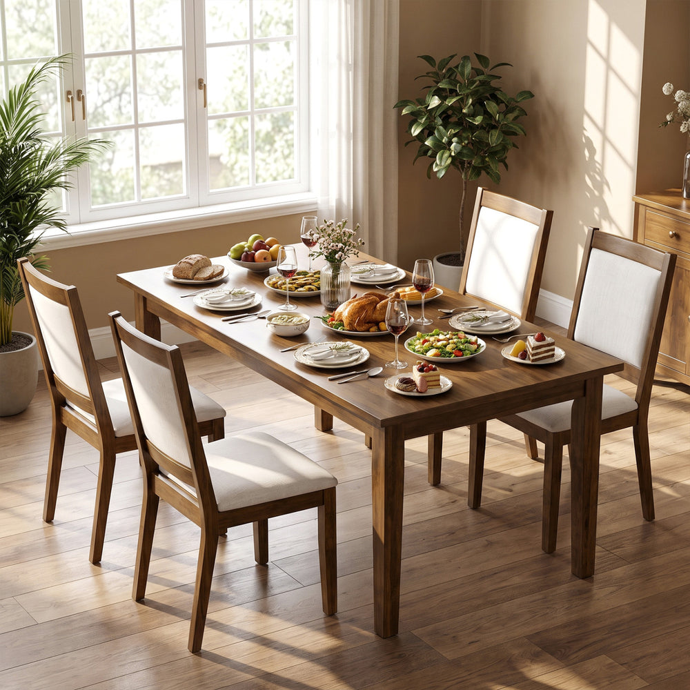 Modern dining table set with four walnut chairs featuring padded beige cushions for comfort and elegant design.