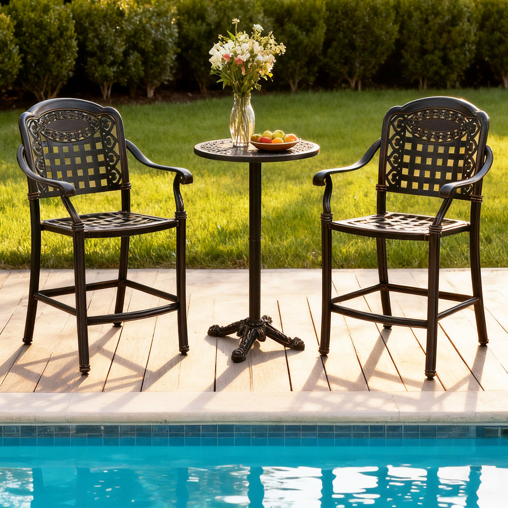 Two cast aluminum outdoor bar stools with a round table, perfect for poolside relaxation and patio gatherings.