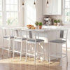 Set of 4 white upholstered barstools with solid rubber wood frame, featuring a tilted backrest for comfort in a kitchen.