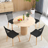 Set of 4 black Windsor dining chairs with spindle backs around a round wooden table, ideal for dining rooms and.