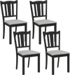 Single black wooden dining chair featuring a soft-padded cushion and ergonomic hollow back for stylish comfort.