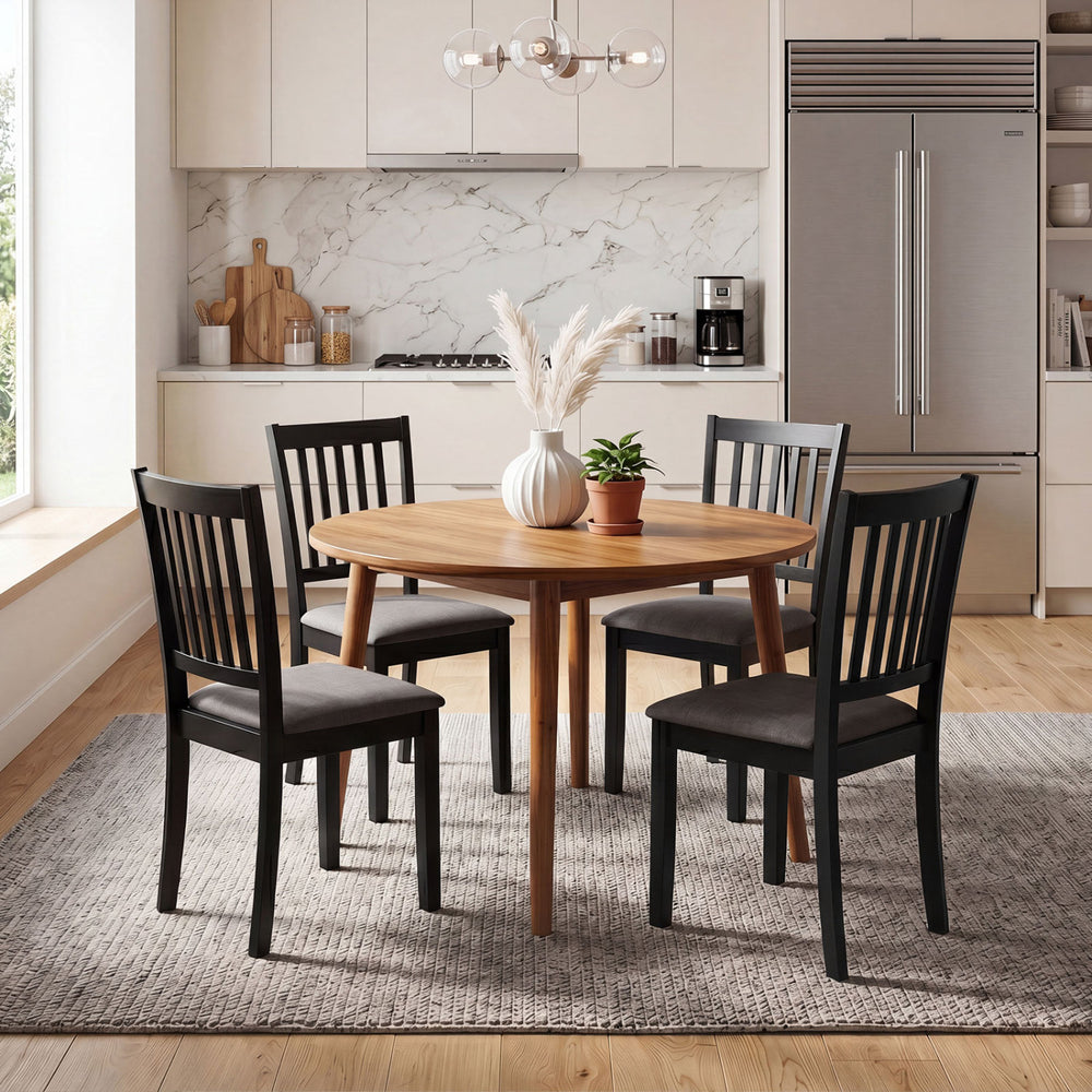 Set of 4 black wooden dining chairs with thick padded seats and rubber wood frames, perfect for dining rooms or kitchens.