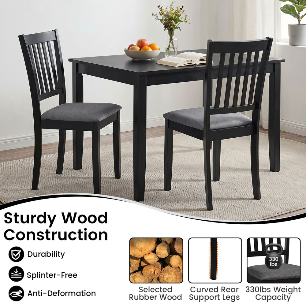 Black wooden dining chair with thick padded seat and rubber wood frame, designed for comfort and durability in dining areas.