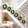 Set of 6 unlit artificial Christmas wreaths with vibrant green leaves, perfect for decorating staircases and indoor spaces.